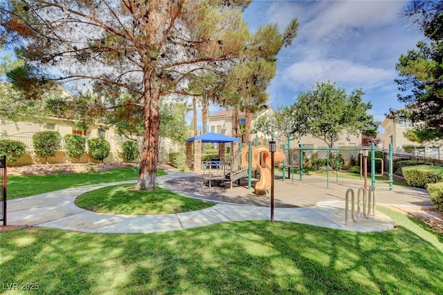 surrounding community featuring a playground and a yard