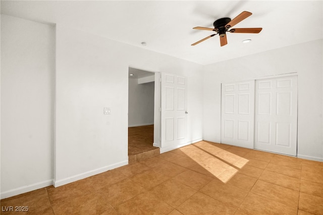 unfurnished bedroom with ceiling fan, a closet, and light tile patterned floors