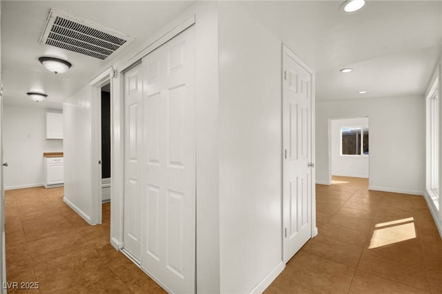 corridor with light tile patterned flooring