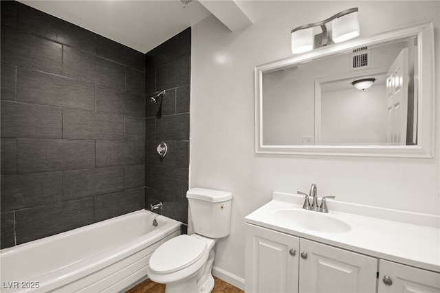 full bathroom with vanity, tiled shower / bath combo, and toilet