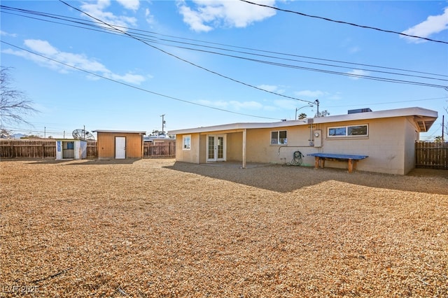 back of property featuring a storage shed