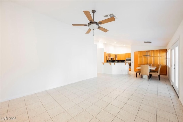 unfurnished living room with lofted ceiling, light tile patterned floors, and ceiling fan