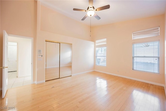 unfurnished bedroom with ceiling fan, light hardwood / wood-style floors, and a closet