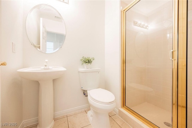 bathroom featuring tile patterned flooring, a shower with door, and toilet