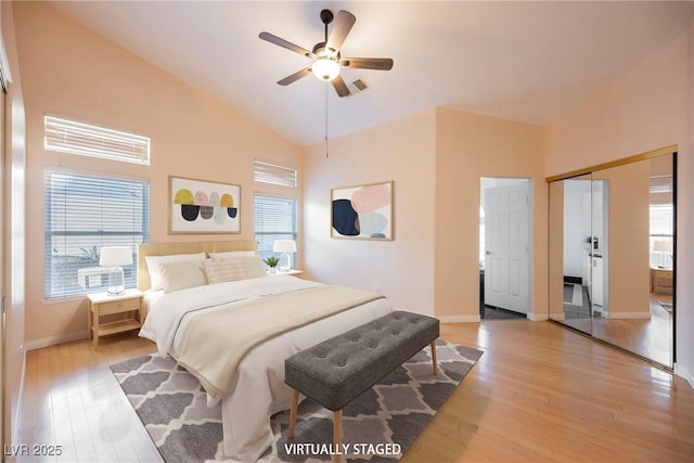 bedroom with multiple windows, ceiling fan, and light hardwood / wood-style floors