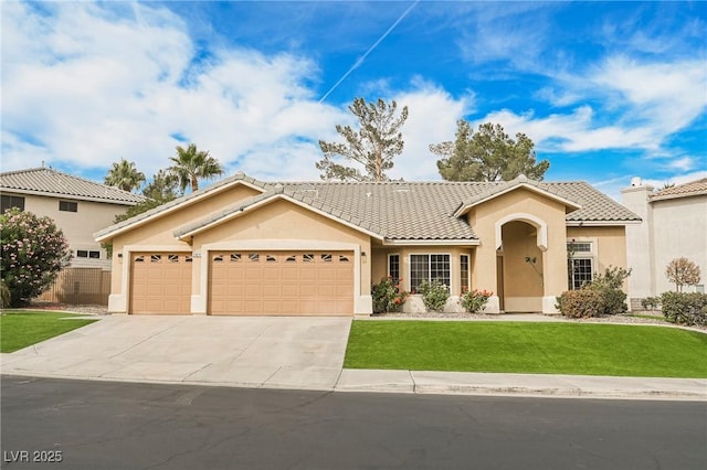 mediterranean / spanish-style home with a garage and a front lawn