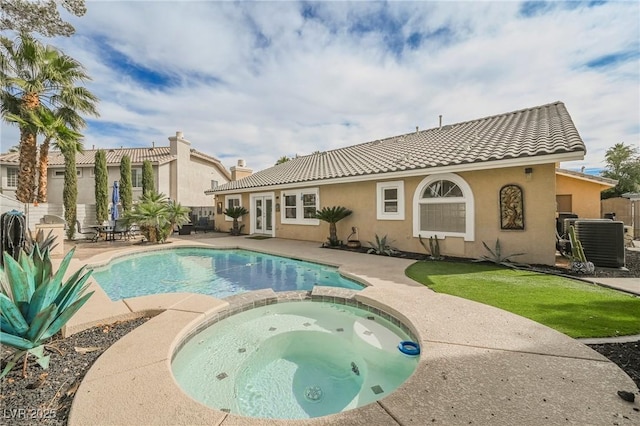 view of pool featuring cooling unit, a patio, and an in ground hot tub