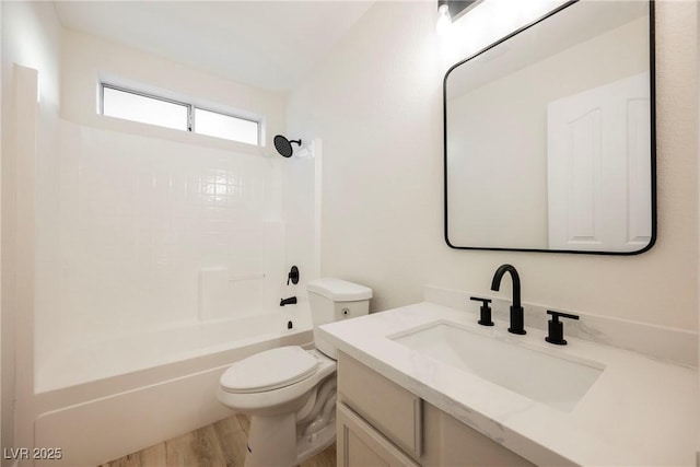 full bathroom with vanity, wood-type flooring, tub / shower combination, and toilet