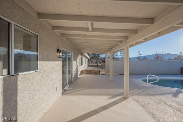 view of patio / terrace with a fenced in pool and a mountain view