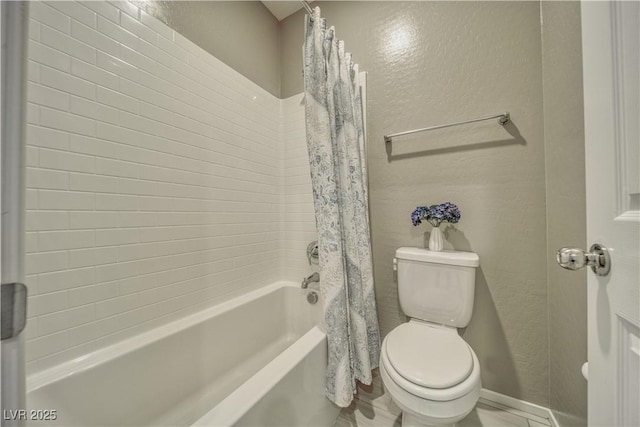 bathroom with shower / bath combination with curtain and toilet