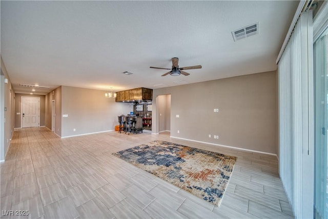 interior space featuring ceiling fan with notable chandelier