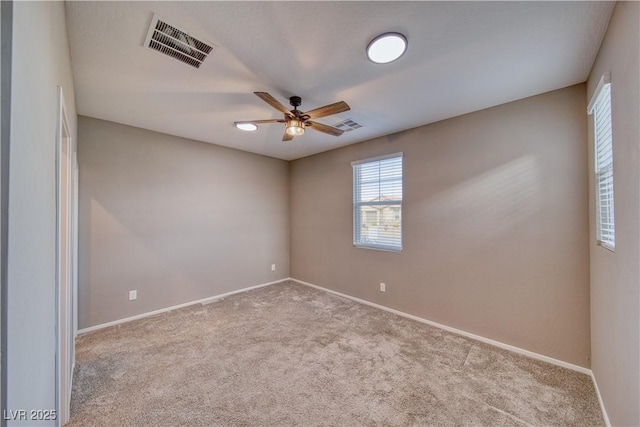 empty room with ceiling fan and light colored carpet