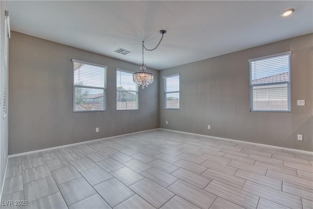 empty room featuring a notable chandelier