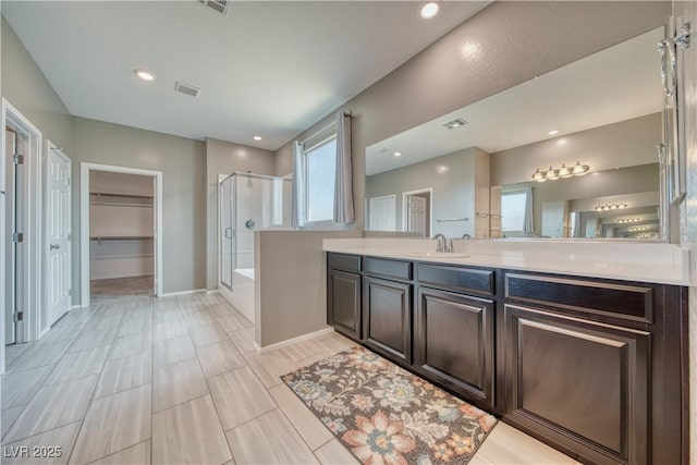 bathroom featuring vanity and shower with separate bathtub