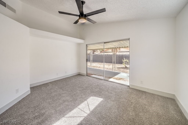 carpeted spare room with ceiling fan, lofted ceiling, and a textured ceiling