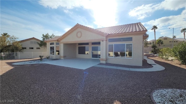 back of property with a patio