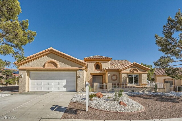 mediterranean / spanish home featuring a garage