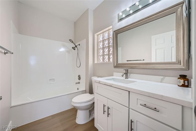 full bathroom featuring  shower combination, toilet, wood-type flooring, and vanity