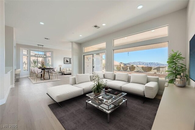 living room featuring a mountain view and hardwood / wood-style floors