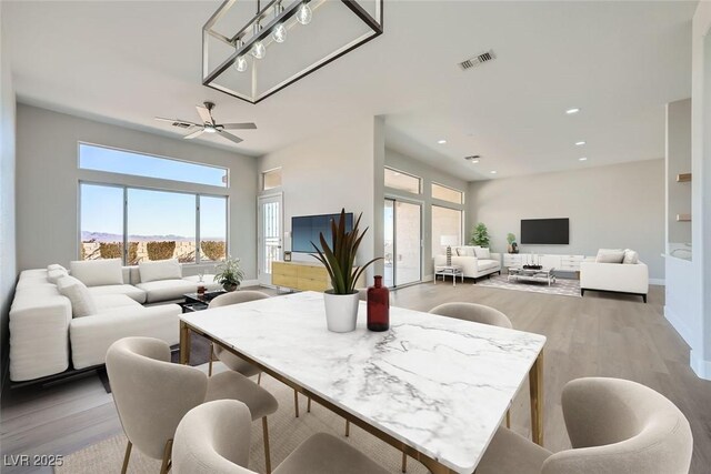 dining room with ceiling fan and light hardwood / wood-style flooring