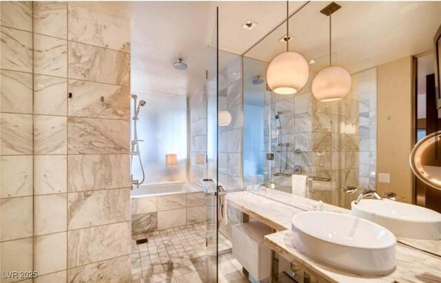 bathroom with sink and independent shower and bath