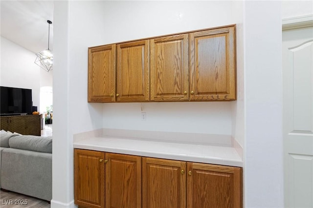 kitchen featuring decorative light fixtures and light hardwood / wood-style flooring