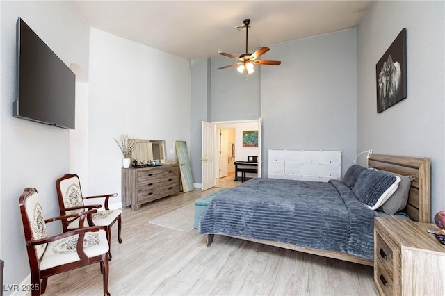 bedroom featuring lofted ceiling, ceiling fan, and light hardwood / wood-style flooring