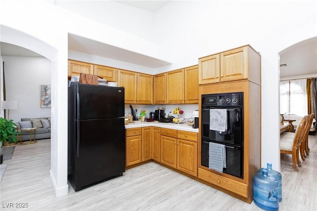 kitchen featuring black appliances and light wood-type flooring