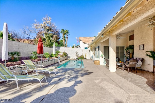 view of swimming pool with a patio and ceiling fan