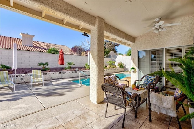 view of patio / terrace featuring ceiling fan and a fenced in pool