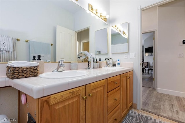 bathroom featuring hardwood / wood-style flooring and vanity