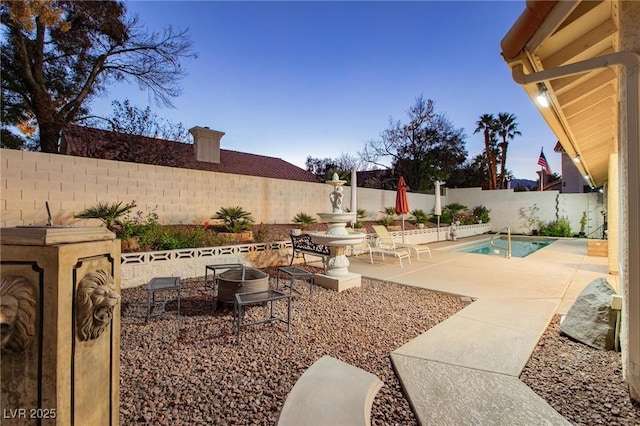 exterior space with a fenced in pool and a patio area