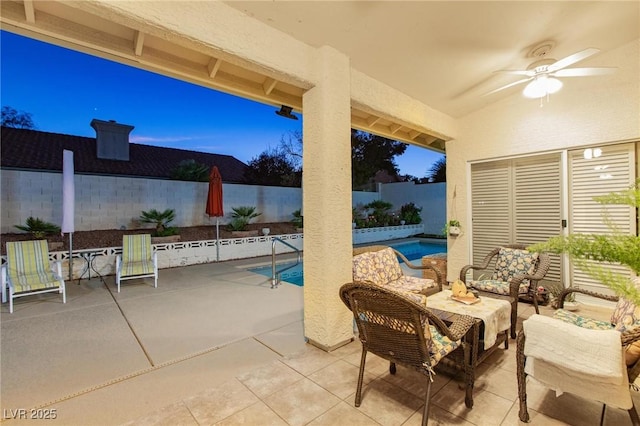 view of patio / terrace with ceiling fan and a fenced in pool