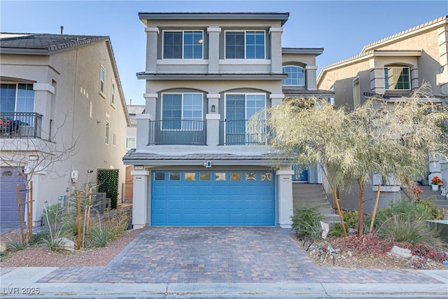 view of front of property featuring a garage and central AC unit