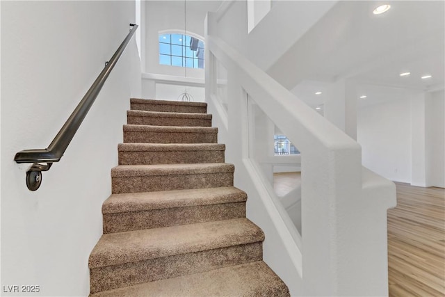 stairs with hardwood / wood-style flooring