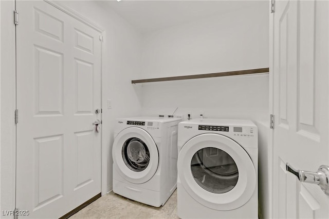 washroom featuring independent washer and dryer and light tile patterned floors