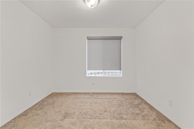 spare room featuring light colored carpet