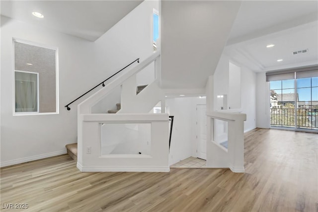 staircase with hardwood / wood-style floors