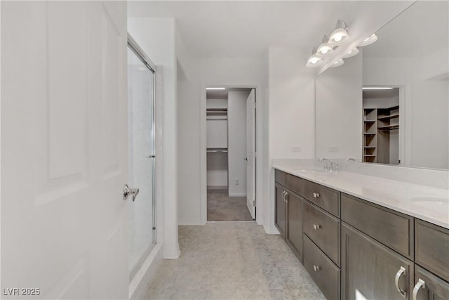 bathroom featuring vanity and a shower with shower door