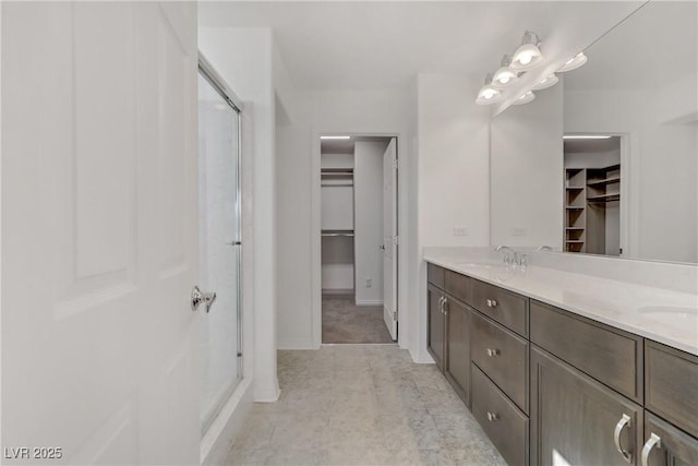 7075 Jasper Hill Way, Las Vegas, NV 89118 - full bathroom featuring a spacious closet, double vanity, a shower stall, and tile patterned flooring