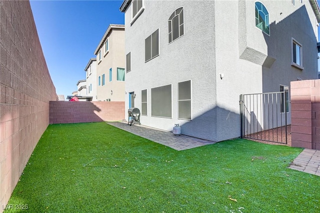 rear view of house with a yard and a patio area