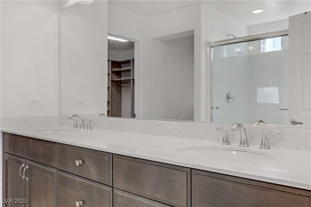 7075 Jasper Hill Way, Las Vegas, NV 89118 - full bathroom with double vanity, a stall shower, and a walk in closet