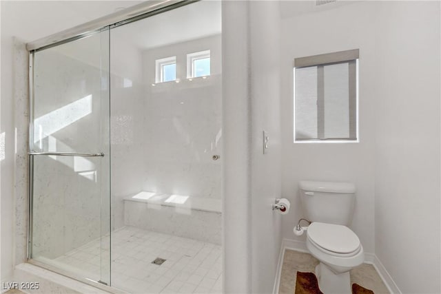 bathroom featuring toilet and walk in shower