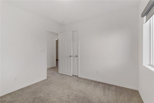 carpeted empty room featuring a wealth of natural light