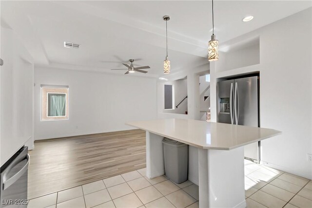 7075 Jasper Hill Way, Las Vegas, NV 89118 - kitchen featuring stainless steel refrigerator with ice dispenser, light countertops, light tile patterned floors, hanging light fixtures, and a ceiling fan