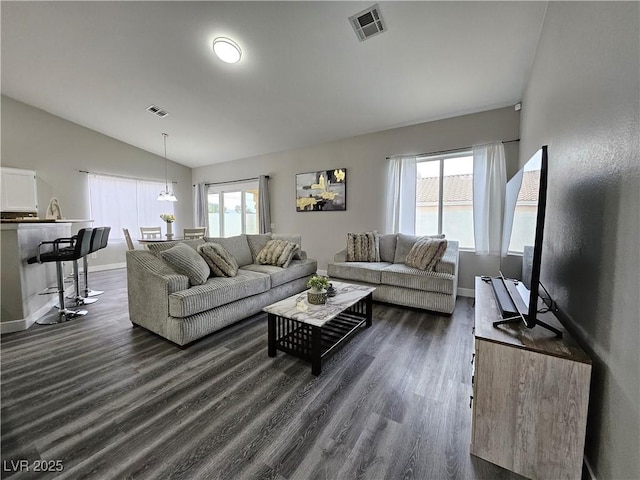 living room with dark wood-type flooring and vaulted ceiling