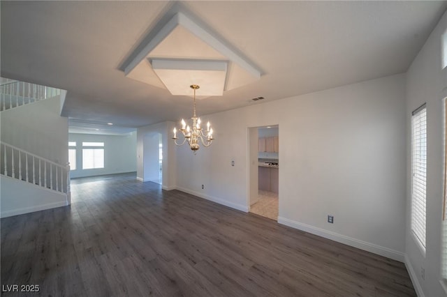 unfurnished dining area with dark wood-type flooring and a chandelier