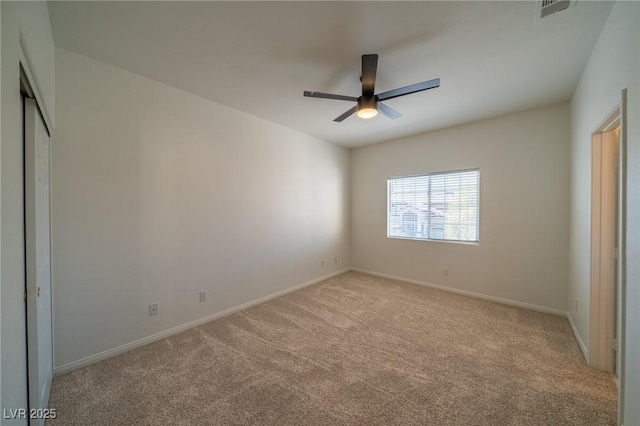 unfurnished bedroom featuring ceiling fan, a closet, and light carpet