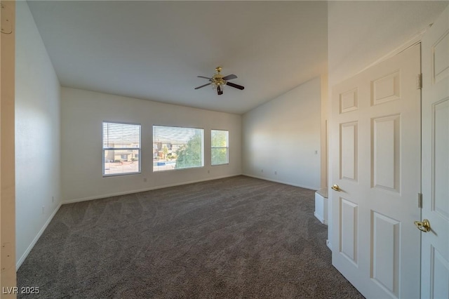 empty room with dark colored carpet and ceiling fan