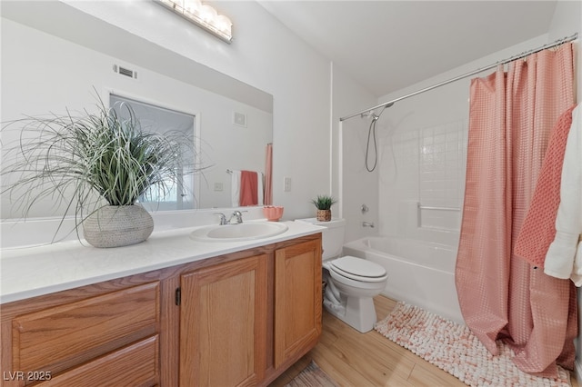 full bathroom with wood-type flooring, shower / bathtub combination with curtain, vanity, and toilet